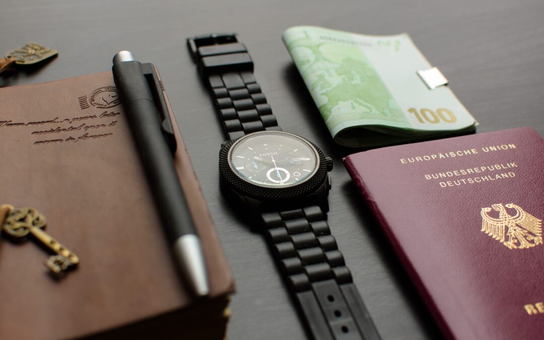 Round Black Chronograph Watch on Table Near Germany Passport an Banknote on Table